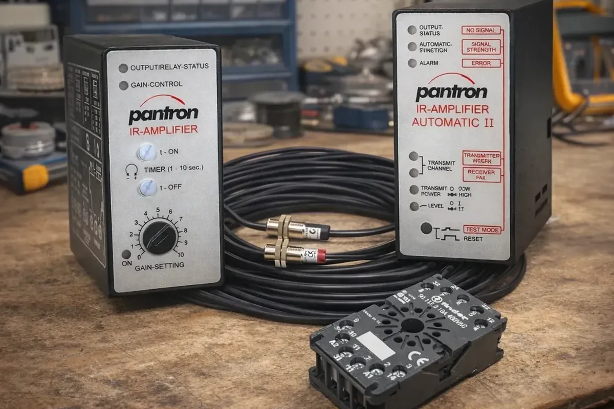 Technician troubleshooting a photoelectric sensor alignment problem on an industrial conveyor